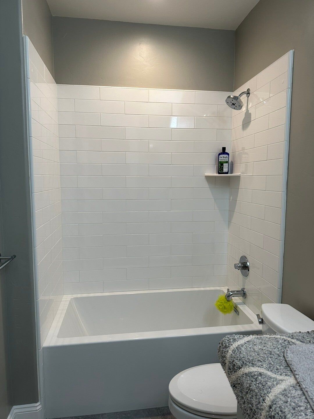 Tub and shower with subway-tile walls, before