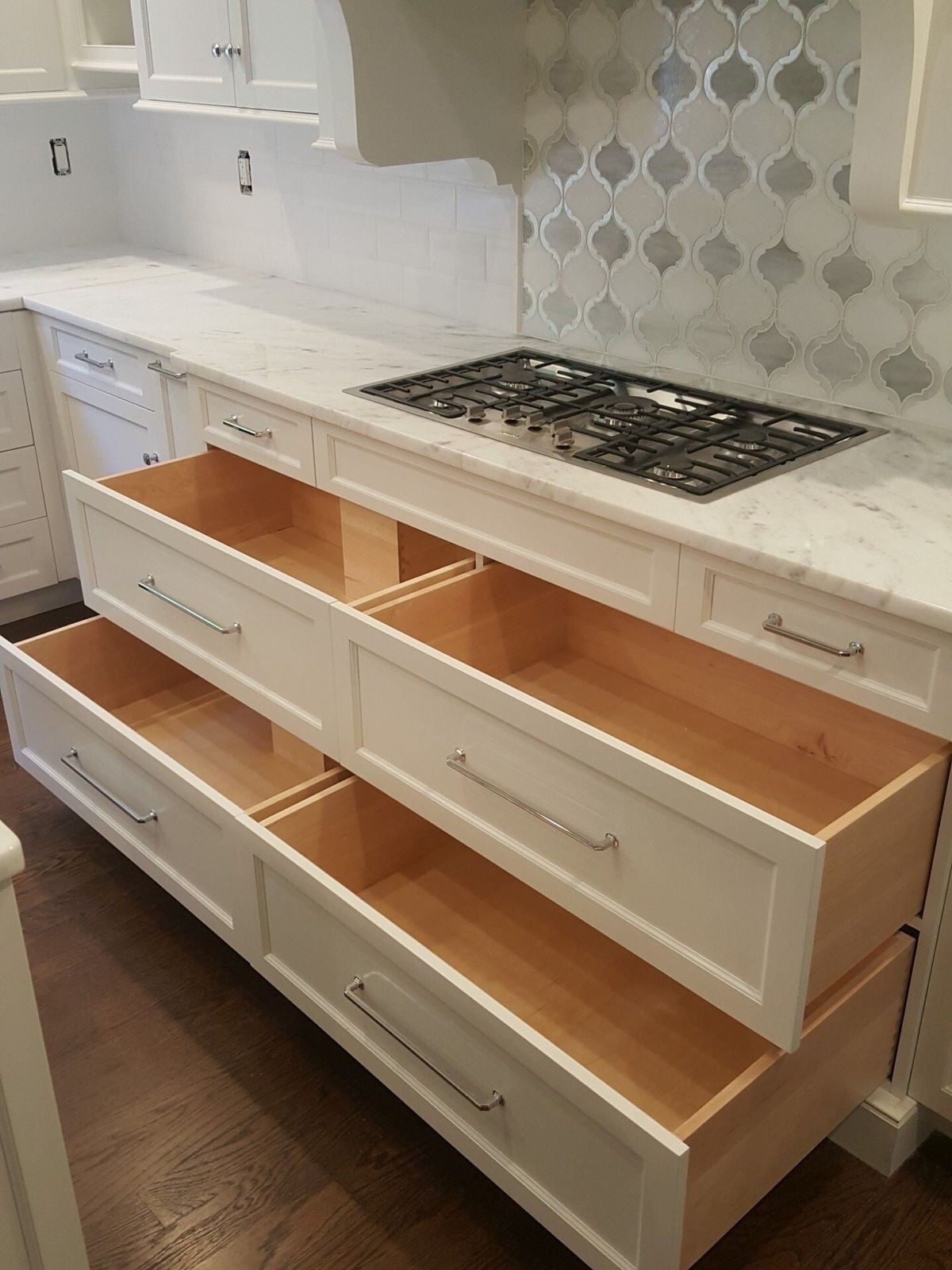 Custom kitchen drawers open to show deep storage