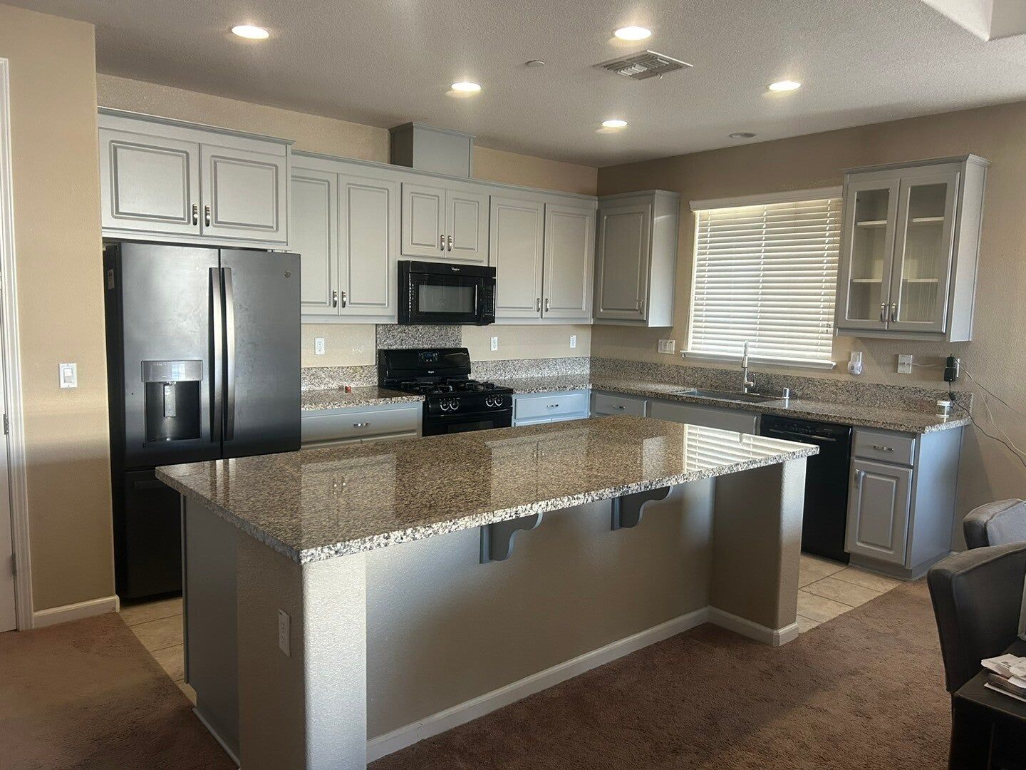 Dark cabinets refaced in light gray, after