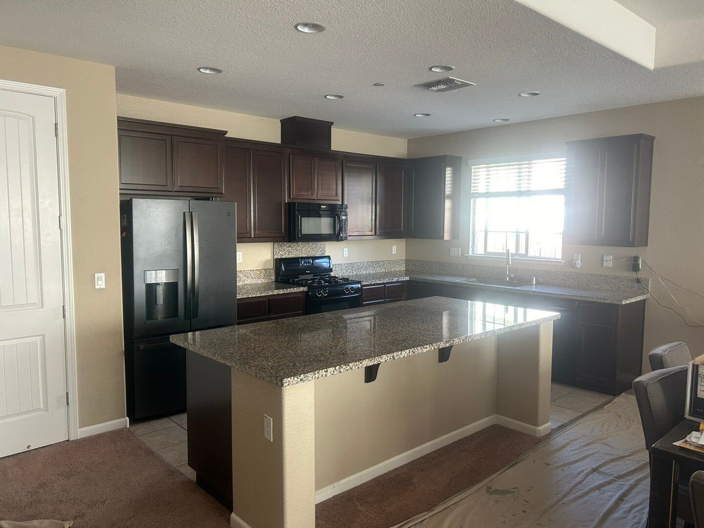 Dark cabinets refaced in light gray, before