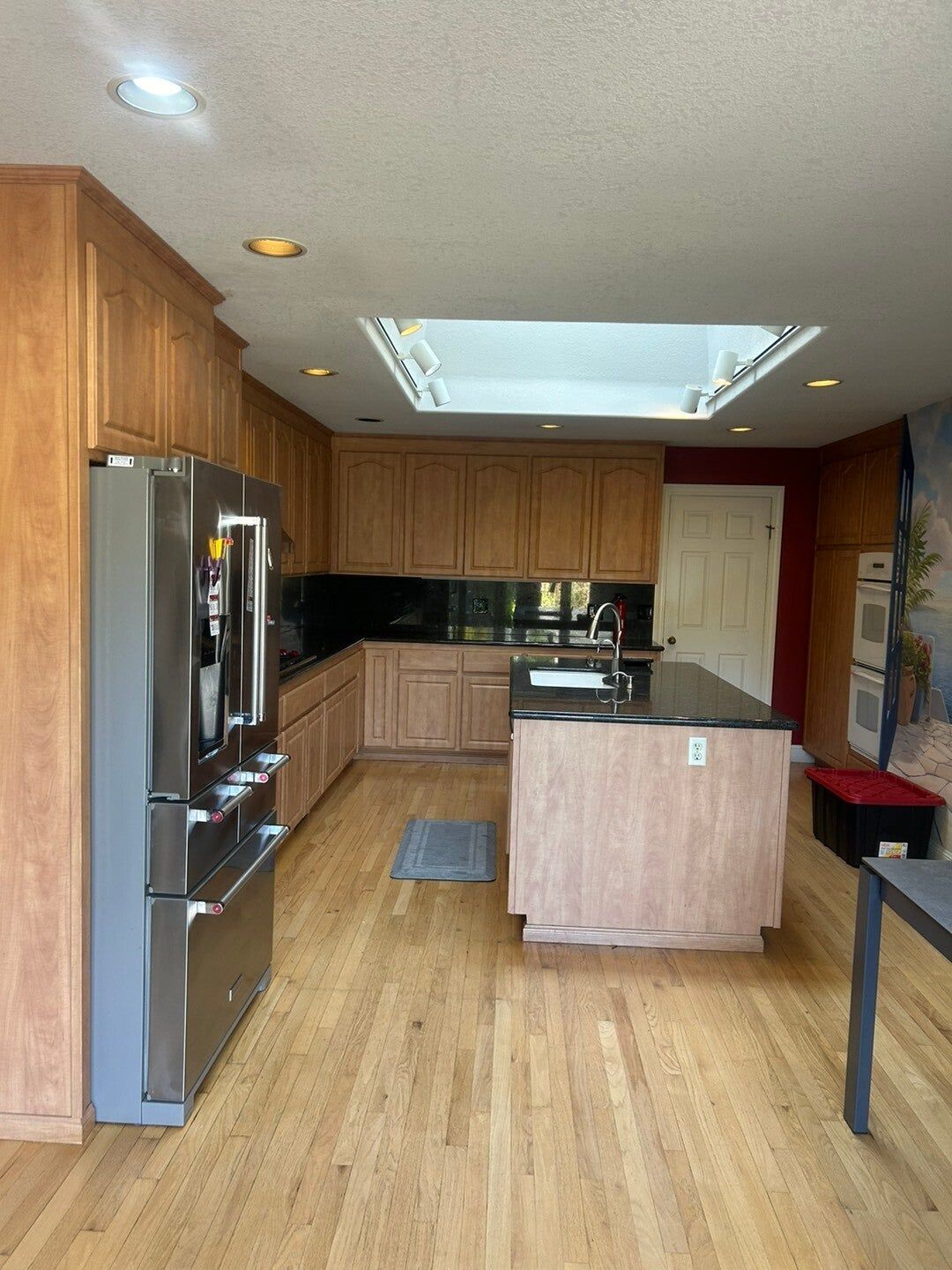 Wood kitchen refaced in white with a navy island, before