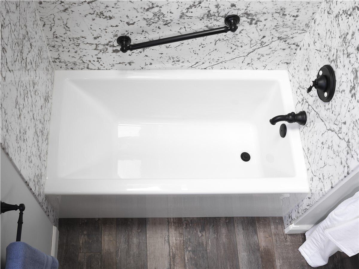 Bathtub with marble-look walls and black fixtures