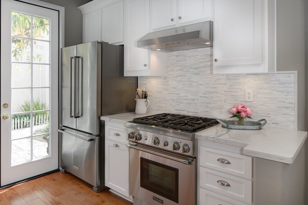 Refaced kitchen with white cabinets and stainless range